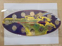 Front view of the set showing 14 Canadian 25-cent commemorative quarters placed on a purple map of Canada with the text 'Millennium Canada Millennium 2000'.