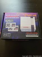 Box of DigitCont Retro Game Console highlighting 620 built-in classic games and controller image.
