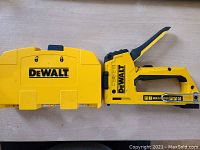 DeWalt yellow staple gun with the handle in a closed position inside a yellow holding case with the DeWalt logo.