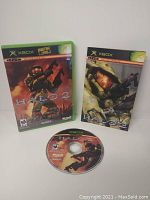 Complete Halo 2 set for Original Xbox with game disc, case and manual showing cover art with Master Chief and the title Halo 2.