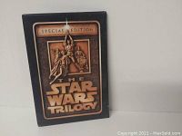 Front view of the vintage Star Wars Trilogy Special Edition pin showing embossed characters and text.