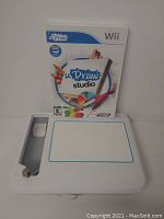 Photo showing uDraw Studio game case in rear with white drawing tablet in front, highlighting product and tablet for Nintendo Wii.