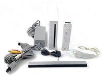 Full view of Nintendo Wii console with connectors and remote controls plus cables and sensor bar.