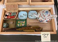 Overview of all lot items on wooden tray