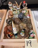 Top view showing assembled animal and bird figurines on wooden tray
