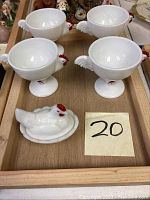 Four white milk glass chicken-shaped custard cups with red painted details and one white milk glass hen on nest trinket dish inside a wooden tray, seller notes wooden tray is not included.