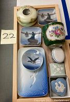 Full view of assorted vintage porcelain dishes, boxes, and holder on wooden tray, showcasing Royal Copenhagen, Spode, Limoges, Wedgwood, and Dedham items.