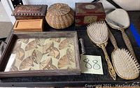 Full lot overview showing all items including brushes, mirror, basket, tray, and wooden boxes on a table