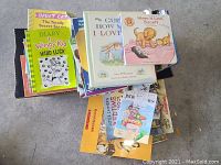 Stack of children's books showing various titles including Diary of a Wimpy Kid and others