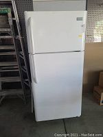 Closed view of white Frigidaire refrigerator showing front and handles.
