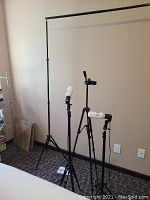 Two black adjustable background stands connected by a horizontal crossbar