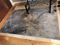 Grey 6x4 feet area rug in foyer with subtle abstract pattern under rack near door