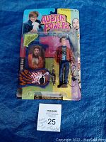 Full frontal view of the unopened Scott Evil action figure in original Austin Powers packaging. Signature visible on the plastic bubble.