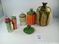 Full set of ceramic vegetable-themed canisters, extra lid, and salt & pepper shakers.