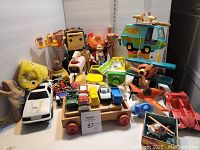 Full assortment of vintage toys showing robot, action figures, Scooby Doo Mystery Machine, planes, and various vehicles.