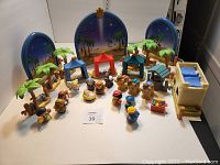 Full overview of set showing characters, animals, scenery, and backdrop arranged on table.