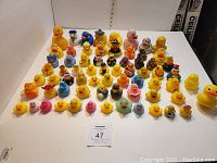 Overview photo showing all rubber duck items arranged in rows demonstrating the various sizes and themes including classic and novelty ducks