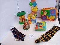 Full lot view with lunchbox, thermos, ties, figurines, and wall hanging displayed