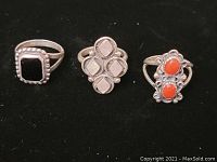 Three Native American sterling silver rings displayed on black background