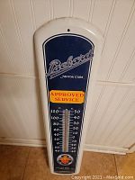 Front view of the vintage Packard Motor Cars thermometer showing the logo, temperature scales in F and C, and Approved Service badge.