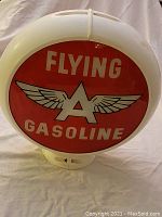Front view of the Flying A Gasoline globe showing the red circular face with the logo and text.