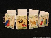 Close-up of the vintage Chinese tile bracelet showing detailed hand-painted scenes of people and animals on ivory-colored rectangular tiles, linked by metal connectors.