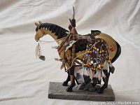 Front side view of the Native American warrior horse figurine showing detailed accessories and painted designs.