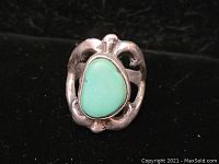 Front view of vintage sterling silver ring showing pear-shaped turquoise stone and sandcast band design.