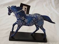 Left side view showing the horse's snowflake design and attached tag.