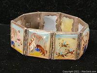 Front view of sterling silver hinged bracelet with enameled tile panels depicting Asian scenes