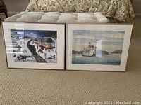 Two framed pictures: one of a vintage train in a snowy station, one of a steamboat on water with mountains in background. Both have mats and simple frames, sitting on carpet floor.