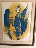 Full view of framed serigraph showing abstract design in blue, yellow, green and gold.