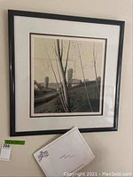 Frontal view of framed lithograph with COA card leaning against bottom edge