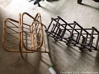 Shows rattan magazine rack on left and wooden wine rack on right, both on carpet