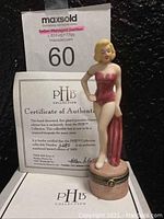 Porcelain Marilyn Monroe figurine on hinged box with certificate and auction lot paper behind