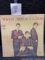 Front cover of Introducing The Beatles album showing band members in suits with Vee Jay Records logo and stereo marking.
