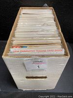 Photo of packaged comics in a white cardboard box, showing the quantity and bagged/boarded protection of comics