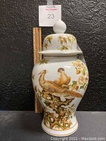 Front view of the porcelain ginger jar, showing two birds on a tree branch with floral accents.