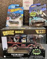 Set of three Batman Batmobile collectibles displayed together showing packaging and product design.
