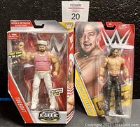 Front view of Tugboat and Shinsuke Nakamura WWE action figures in sealed packaging showing packaging and figures.