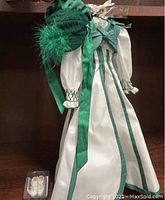 Full view of doll outfit on display including dress, bonnet hat, and shoes in box.