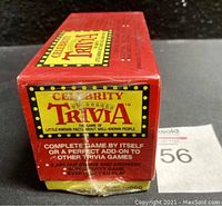 Photo of red and yellow sealed Celebrity Trivia game box showing front with branding and game features.