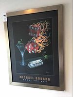 Full view of the framed Michael Godard print titled 'Shoot the Wad'. Image shows flaming dice, a martini glass with an olive, and cash rolled up on a dark background in a silver frame.