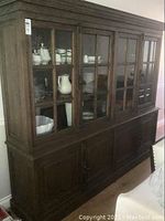 Full front view of wooden hutch loaded with dishes