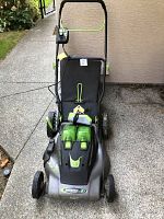 Front view of mower showing deck, handle and two batteries installed