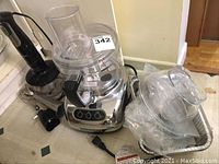 Overview of both items showing KitchenAid processor, Braun hand blender and attachments