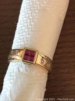 Front view showing square ruby cluster and bezel frame