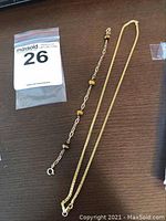 Overview of both bracelet and necklace laid on wooden surface
