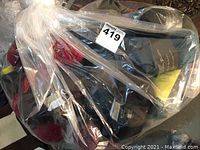 Photo of yarn skeins in a clear plastic bag showing various fall colors and labels with Mission Falls 1824 brand.