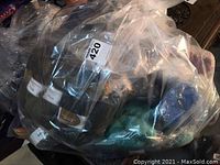 Overview of plastic bag filled with mixed yarn skeins